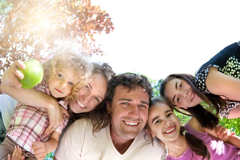family of 5 outdoors around camera